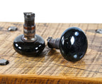 two matching late 1880's american residential "screwless spindle" fired red clay doorknobs with original jet black porcelain enameled finish