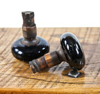 matching set of original american passage door jet black porcelain enameled doorknobs with intact iron "screwless spindle" shanks