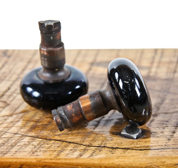matching set of original american passage door jet black porcelain enameled doorknobs with intact iron "screwless spindle" shanks