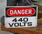 slightly worn late 1940's american vintage industrial "440 volts" die cut steel wall-mount factory danger sign