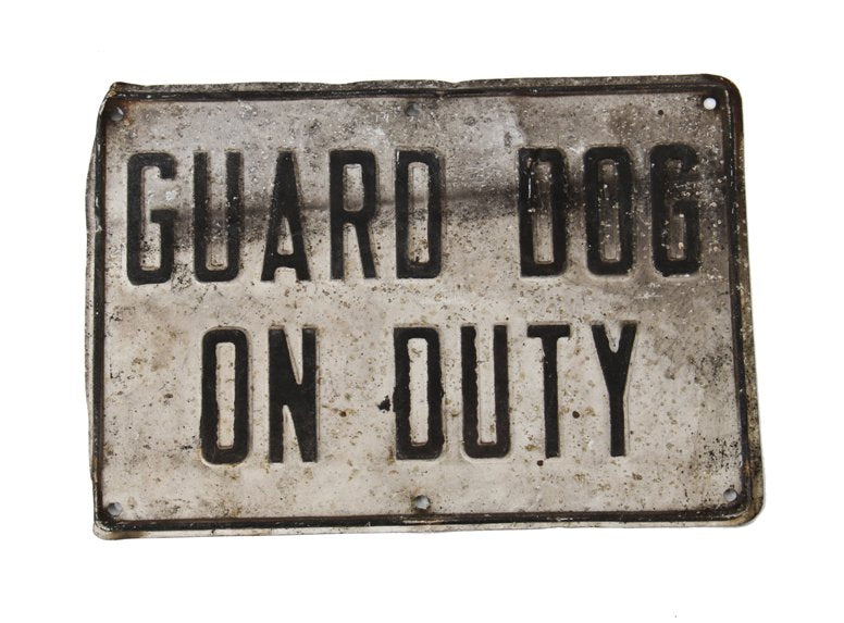 heavily weathered single-sided outdoor vintage industrial "guard dog on duty" embossed metal cautionary sign with black lettering