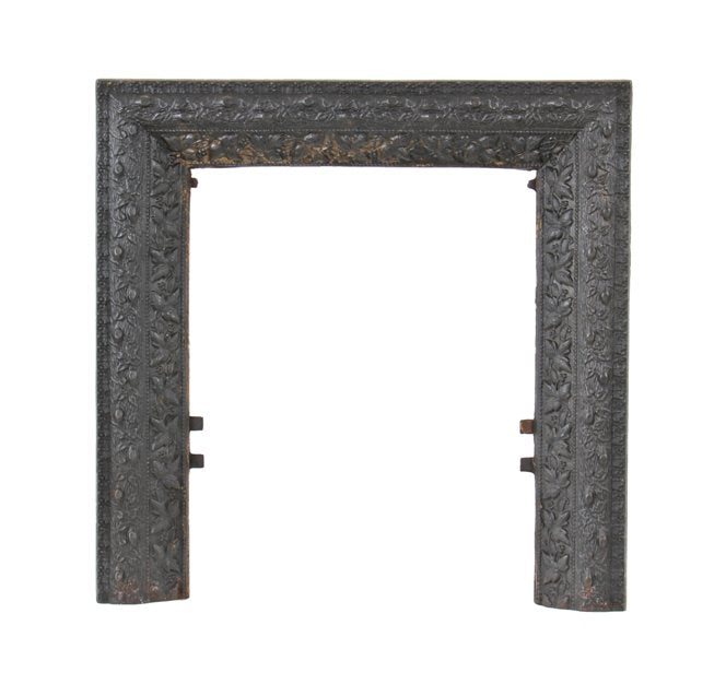 unusual late 19th or early 20th century black enameled ornamental cast iron interior residential fireplace summer cover surround with abundant leafage design motifs