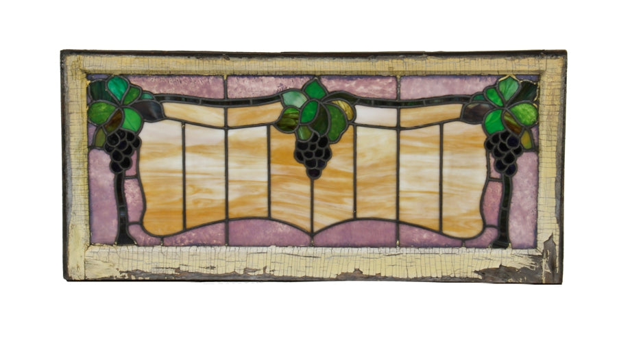 brilliantly colored early 20th century american craftsman style transom art glass window with clusters of berries and leafage