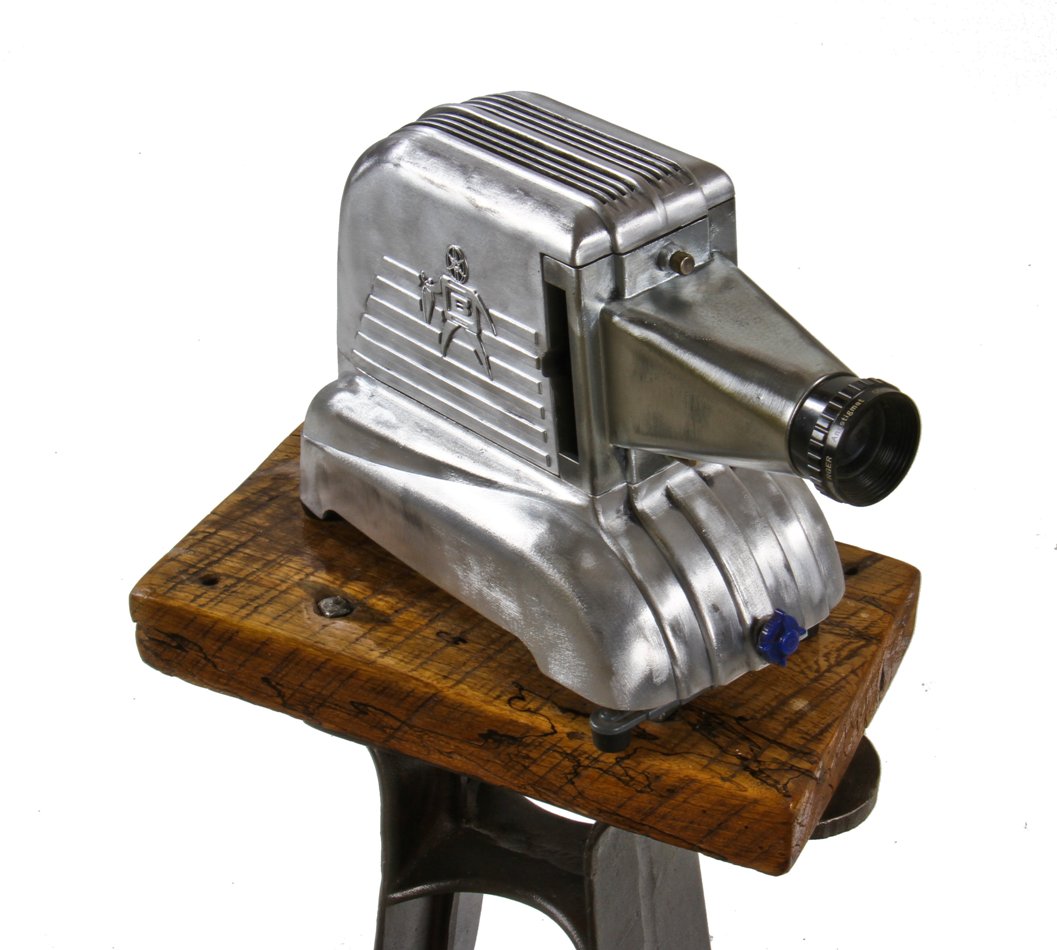 highly stylized vintage american super streamlined cast aluminum portable brumberger electric photographic slide projector