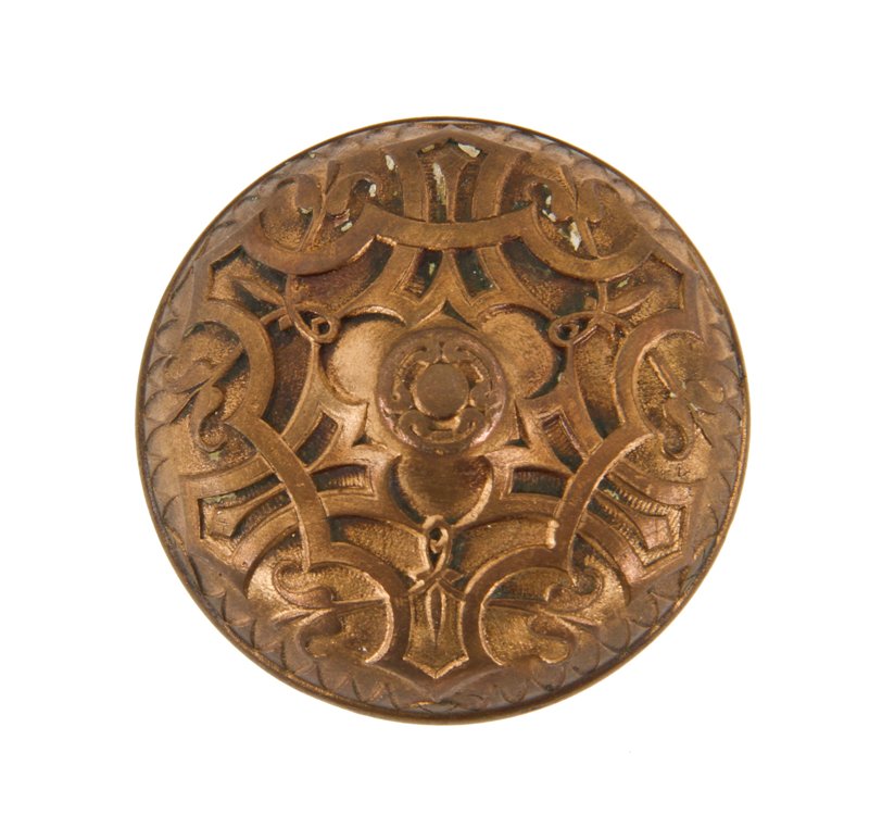 19th century antique american victorian era ornamental cast bronze banded rim residential doorknob with raised center containing a floral motif