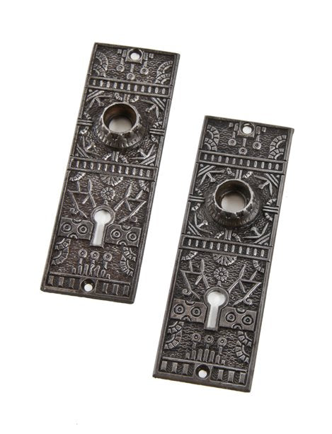 matching set of late late 19th century refinished ornamental cast iron "windsor" pattern eastlake style doorknob backplates