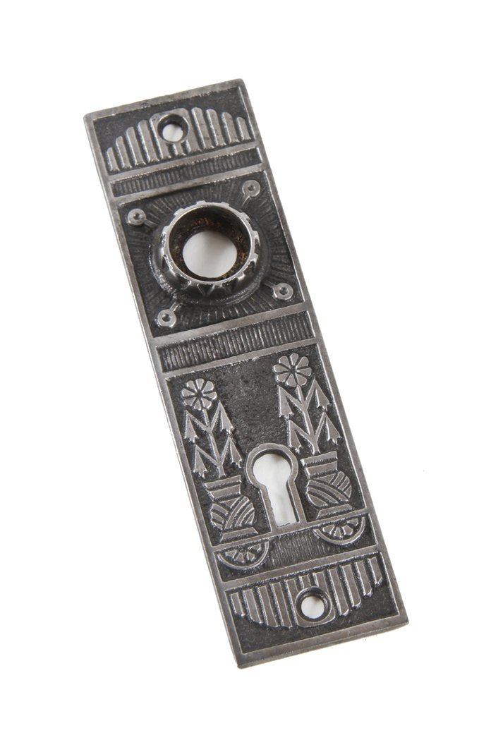 single early 20th century original ornamental cast iron "magnolia" pattern flush mount doorknob backplate with potted plants