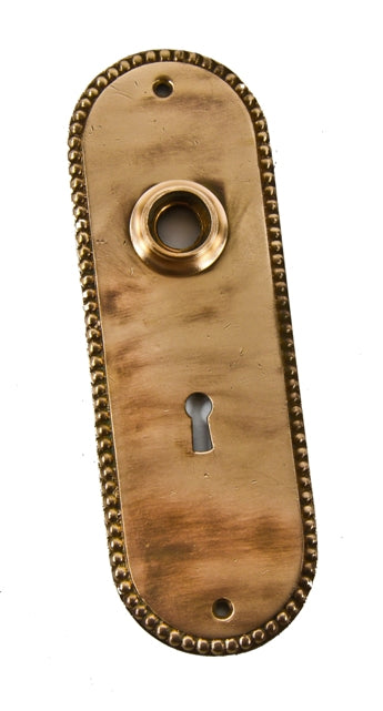 late 19th or early 20th century original interior residential refinished wrought bronze passage door backplate with a beaded border