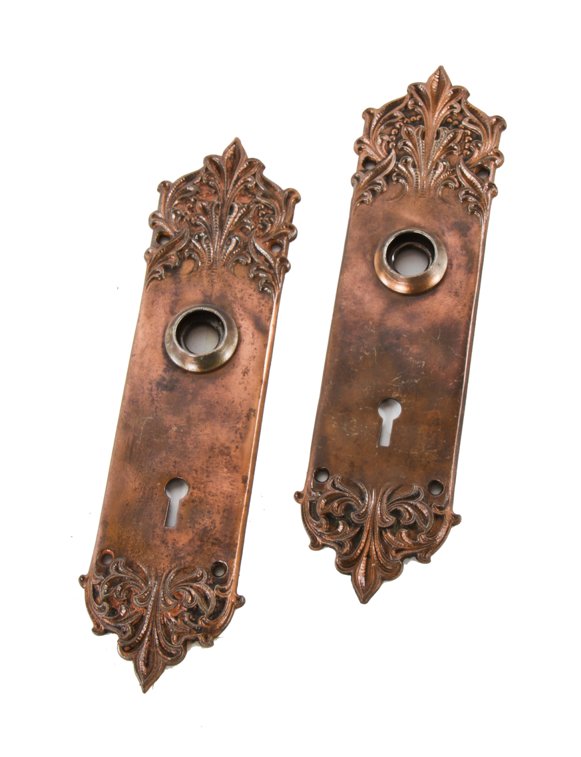 set of original early 20th century antique american ornamental cast iron copper-plated interior residential "panama" pattern doorknob backplates