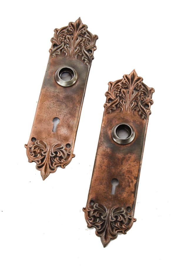 two matching c. 1900's richardsonian romanesque style interior residential ornamental cast iron "panama" pattern doorknob backplates
