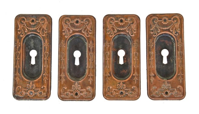 group of four matching original late 19th or early 20th century ornamental wrought brass "clifton" pattern interior residential pocket door backplates