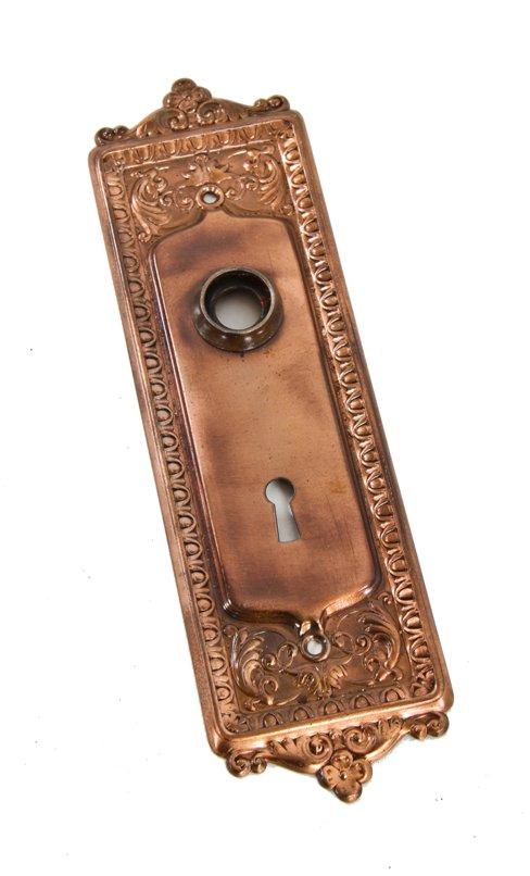 late 19th or early 20th century original copper-plated ornamented stamped steel "mantua" pattern doorknob backplate
