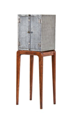 uniquely designed repurposed american industrial riveted joint steel cabinet with a newly added "danish modern" style four-legged tapered and turned base
