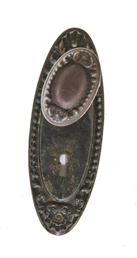 c. 1900's single matching antique american ornamental stamped steel oval-shaped passage door backplate and doorknob