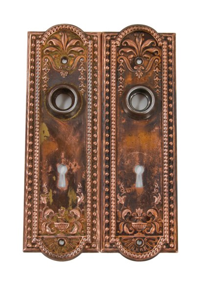 set of original antique american interior residential ornamental wrought steel "como" pattern copper-plated passage door backplates