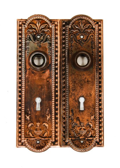 matching pair of original c. 1900's antique american "como" pattern residential doorknob backplates or escutcheons with copper-plated finish