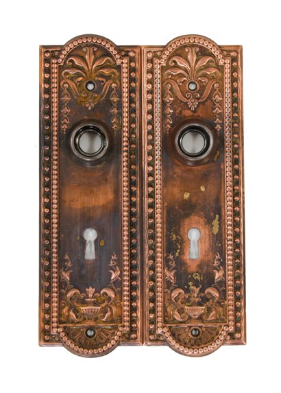 two matching original early 20th century antique american ornamental stamped steel "como" pattern doorknob backplates
