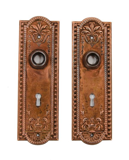 set of original "como" pattern antique american ornamental stamped steel residential doorknob backplates with copper-plated finish