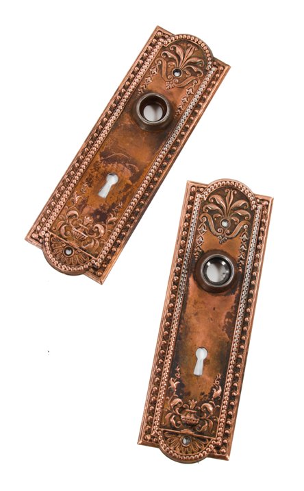 matching early 20th century decorative stamped steel "como" pattern interior residential doorknob backplates with copper-plated finish
