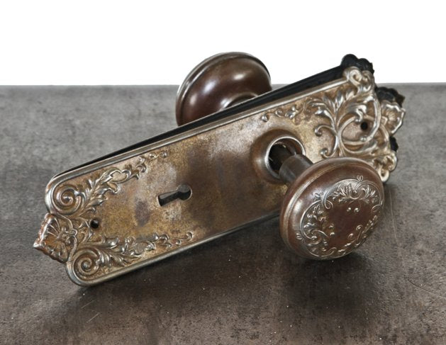 matching set of original c. 1900's american antique "loriane" pattern ornamental wrought steel doorknobs and escutcheons