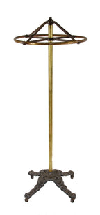 hard to find and highly desirable early 20th century completely intact clothing store garment rack with a heavily ornamented cast iron weighted base