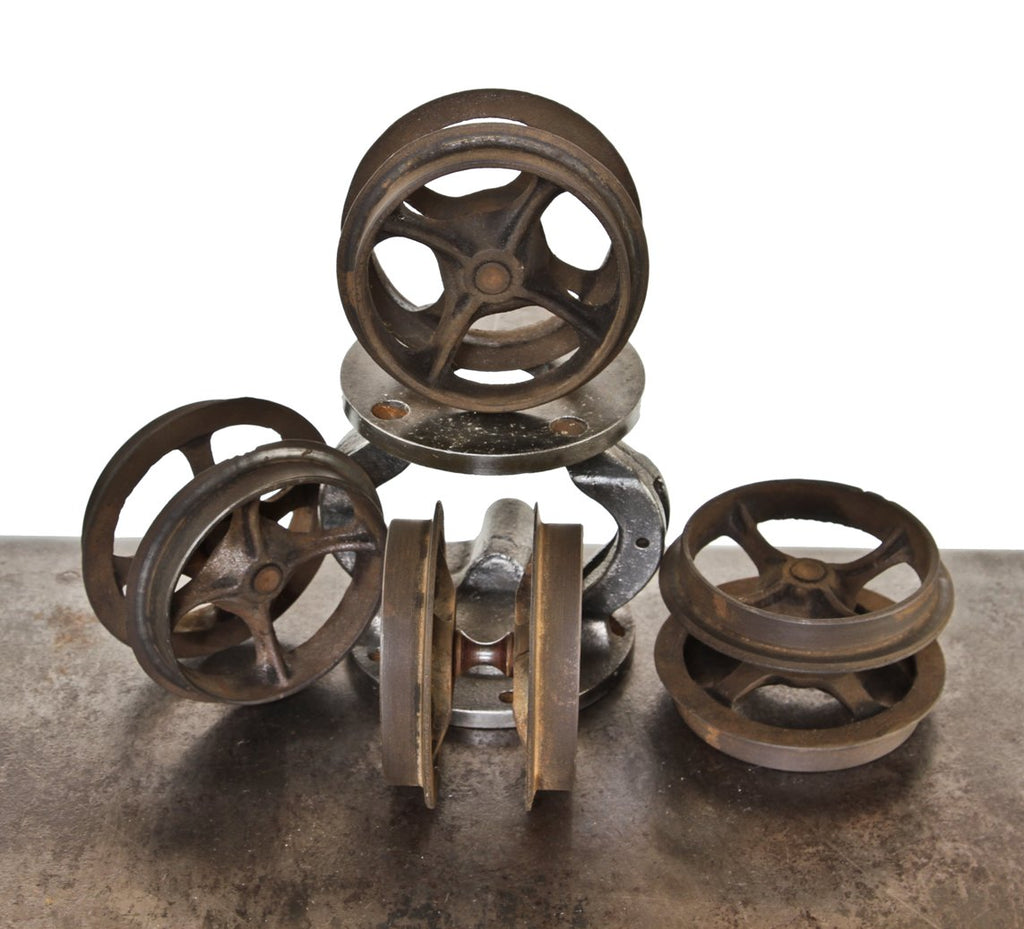 set of four matching 19th century interior residential cast iron improved "wilcox" sliding or pocket door cast iron spoked track rollers
