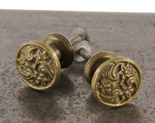 two matching original early 1920's diminutive ornamental cast brass interior built-in cabinet drawer knob pulls with footed shanks