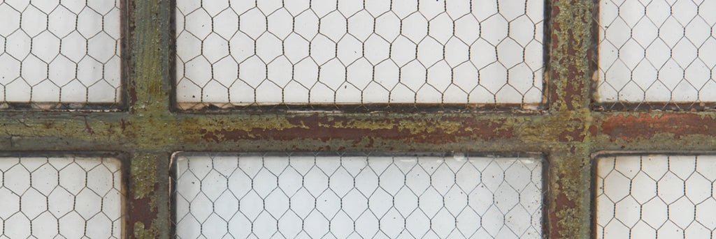 early 20th century hard to find original and intact six-pane "chicken wire" heavy gauge steel factory casement window with weathered green paint finish