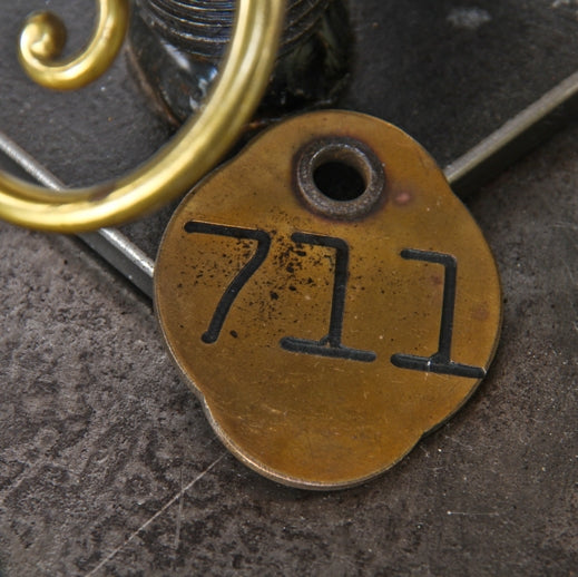 unusually large early 20th century double-sided stamped bronze metal ywca hotel building key floor with lightly incised numbers