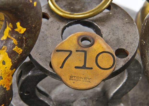 american double-sided oversized solid bronze metal 7th floor ywca hotel number key fob with a nicely aged surface patina