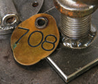 original early 20th century antique american double-sided heavy cast bronze metal ywca building key fob with incised numbers