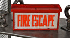 single-sided original and fully functional illuminated ceiling or wall-mount "fire escape" electric can sign with orange enameled lettering