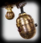 american c. early 20th century ornamental wrought yellow brass two-arm chicago athletic club billiard room ceiling fixture with gold aurene steuben shades