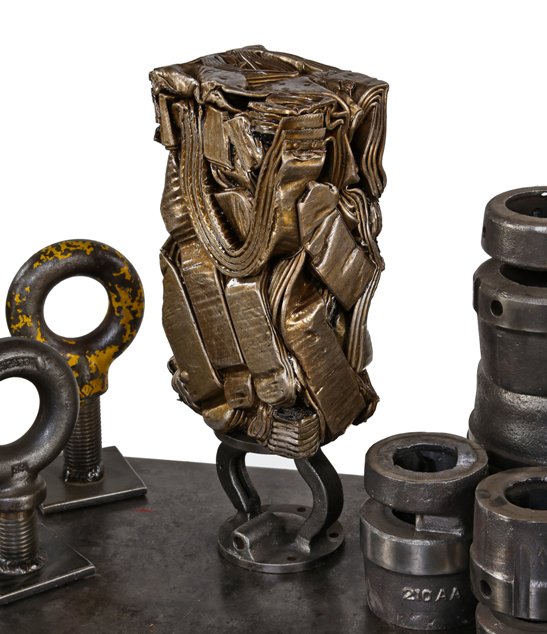 visually distinctive crushed brass metal "briquette" display object consisting of recycled radiator components