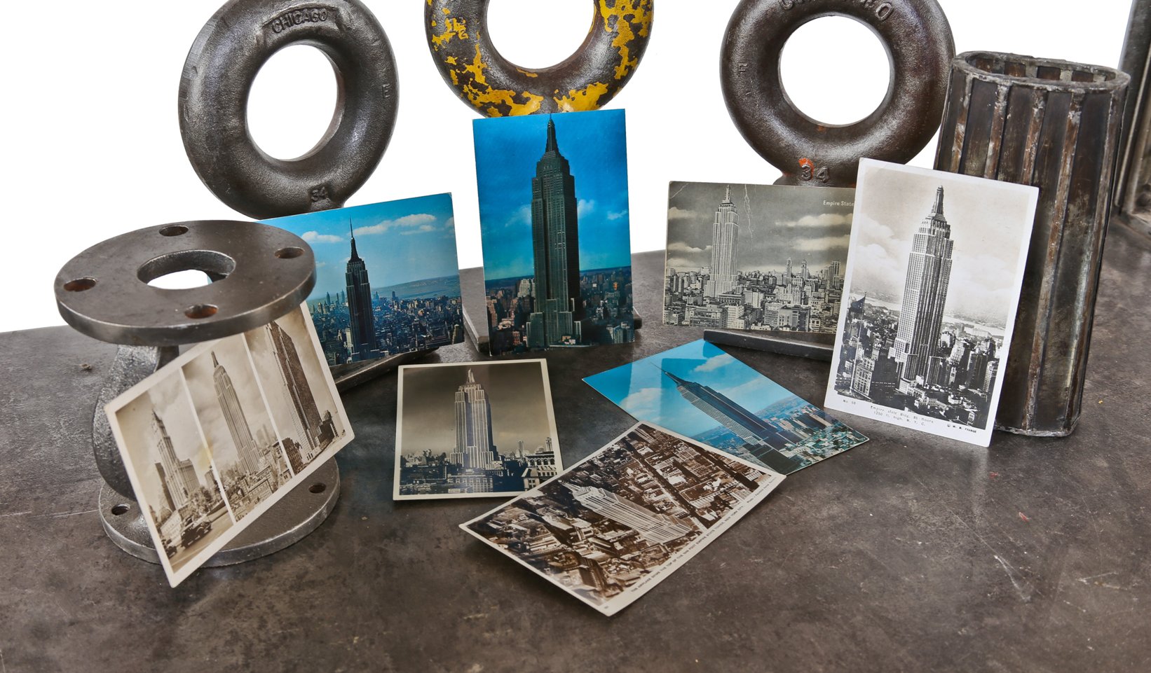 assortment of vintage american printed picture post cards depicting the iconic empire state building throughout the 20th century