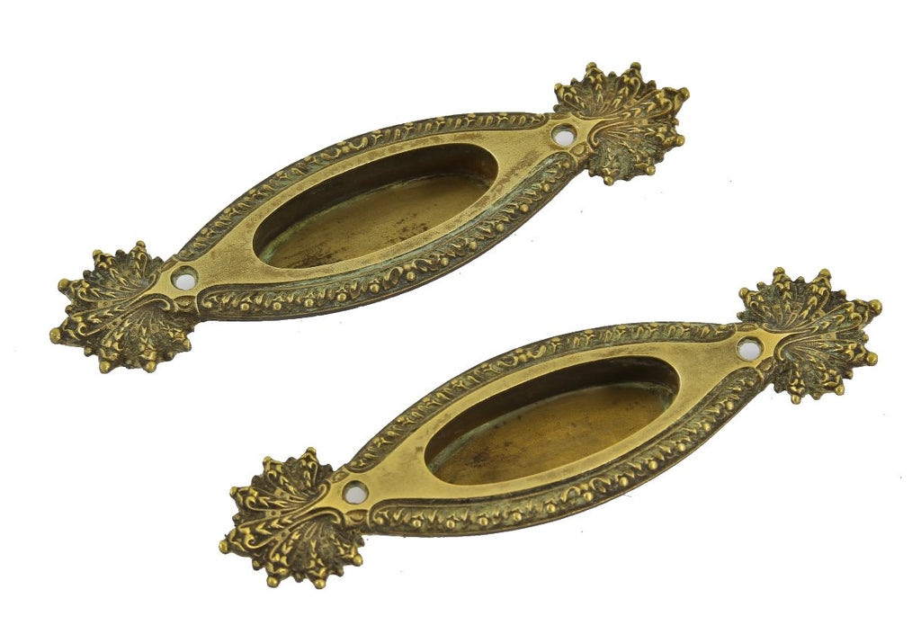 two diminutive early 20th century ornamental cast brass "marquise" pattern interior residential window sash lifts or pulls