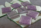 group of eight matching early 20th century "sun purple" tinted frank lloyd wright-designed patented prism glass building transom tiles