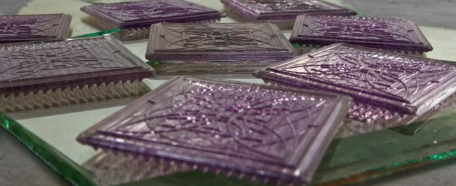 original and highly sought after band of five matching frank lloyd wright-designed "sun purple" ornamental prismatic glass building transom tiles with original soldered caming