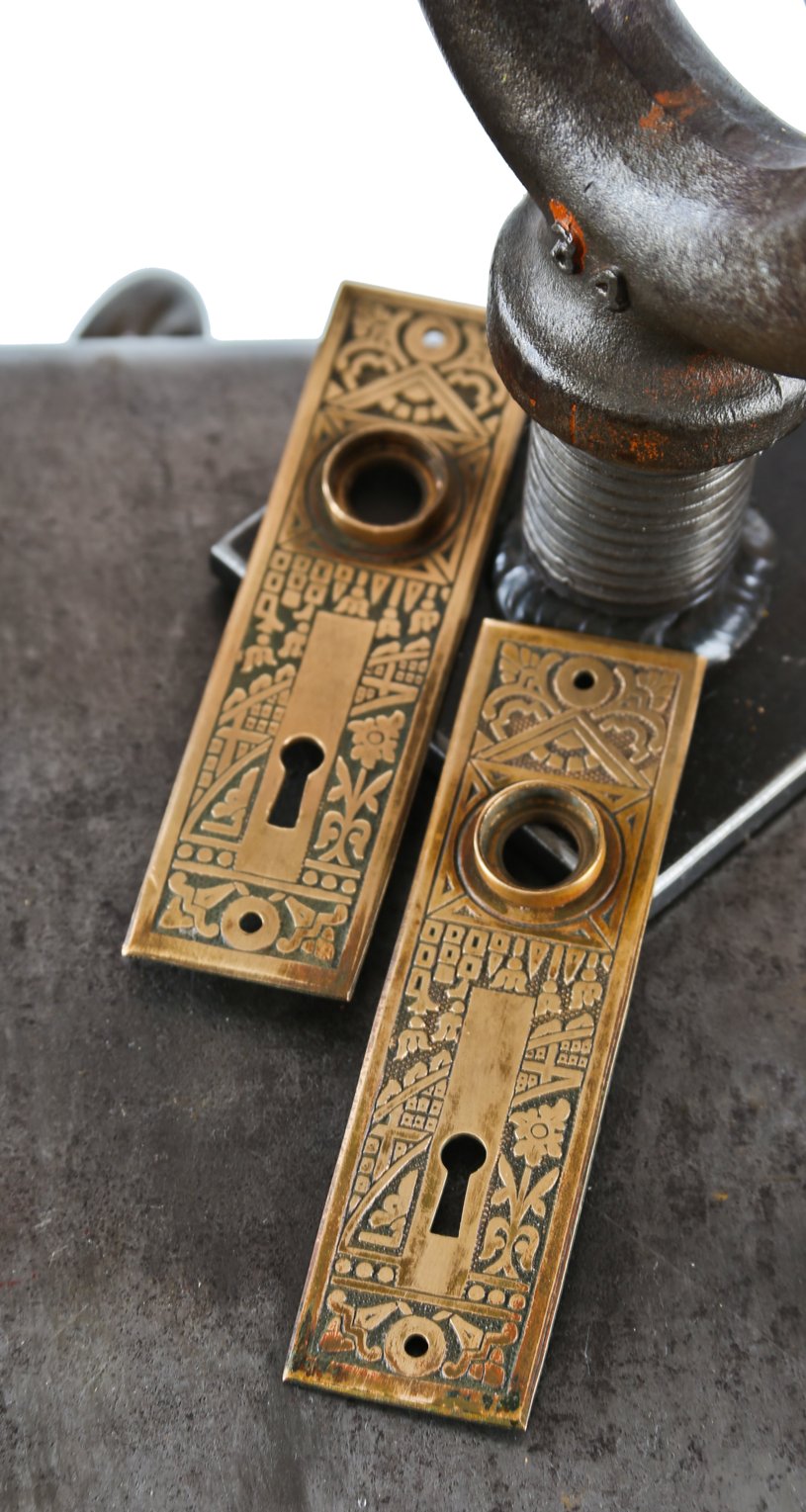 set of original late 19th century highly desirable "ceylon" pattern interior residential ornamental wrought brass doorknob backplates
