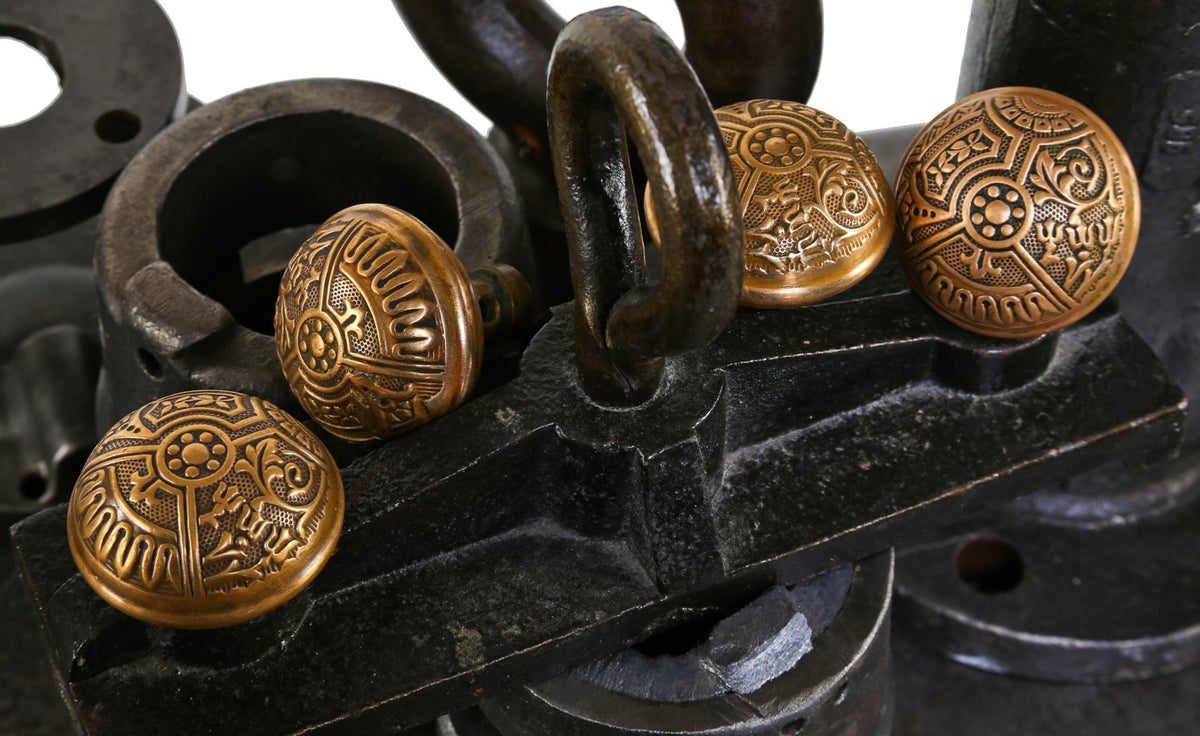 group of four matching original 19th century "ceylon" pattern interior residential dome-shaped wrought brass doorknobs