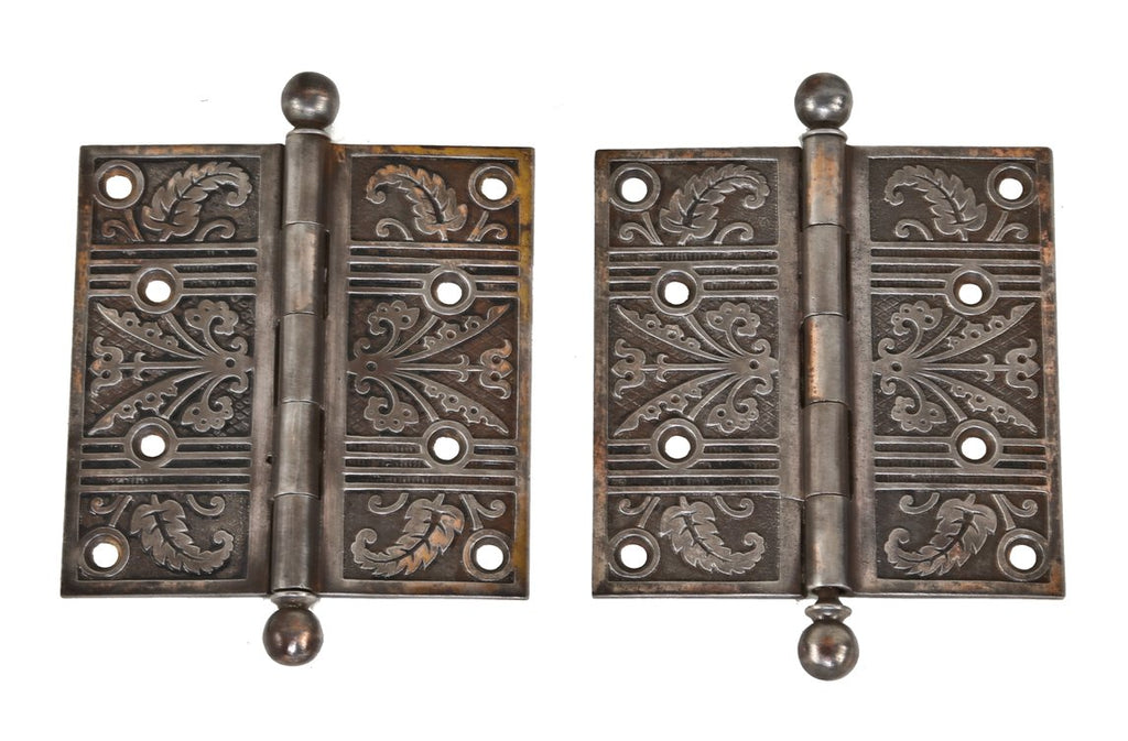 two matching original loose pin ornamental cast iron interior residential door hinges with traces of a copper-plated finish