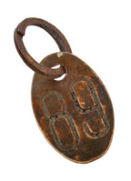 american industrial oval-shaped wrought yellow brass double-sided lightly incised cow identification tag with steel ring