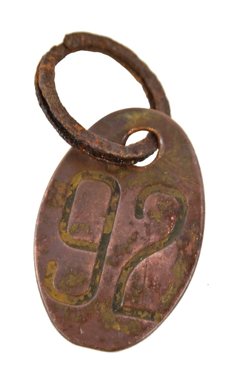oversized american industrial oval-shaped late 1920's stamped wrought brass cow identification tag with lightly incised numbers
