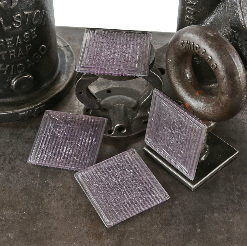 set of four original early 20th century "sun-purple" frank lloyd-wright designed "geometric flower" exterior building transom luxfer prism tiles