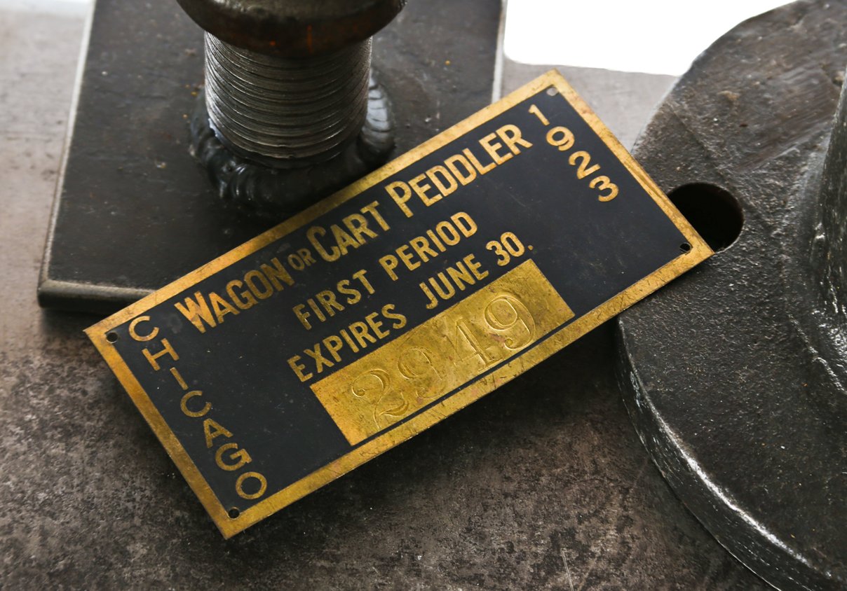 baked black enameled and yellow copper single-sided c. 1920's original stamped city of chicago street peddler license with prominently displayed expiration date