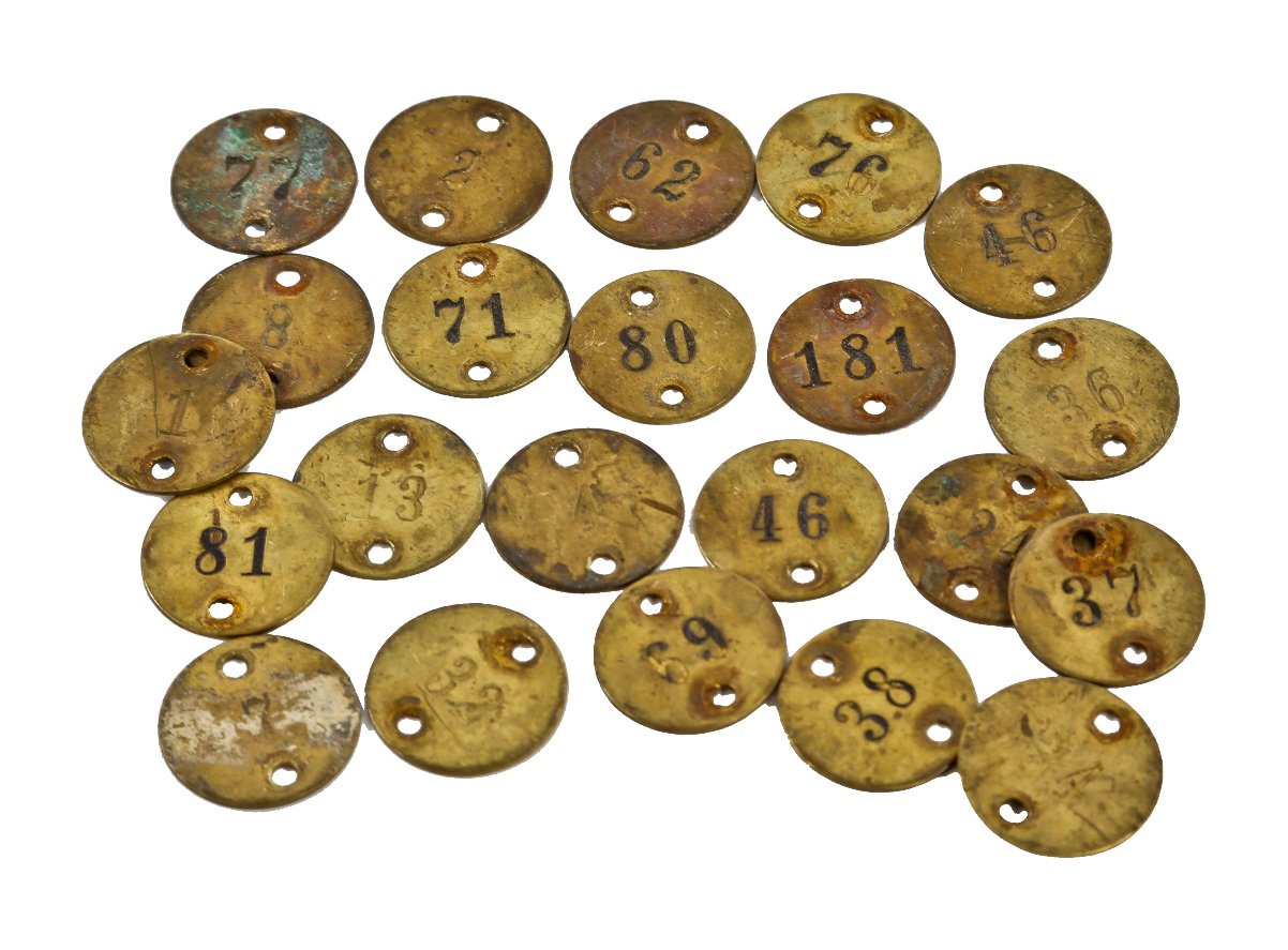 assortment of original early 20th century historic la salle hotel stamped brass incised number coat check circular-shaped tags