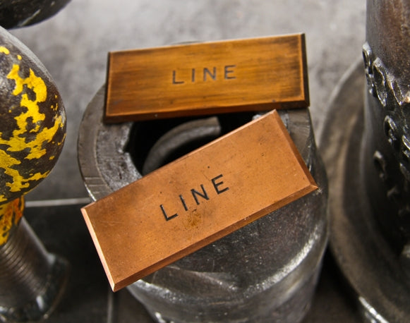 pair of matching early 20th century american industrial single-sided solid copper switchboard identification plaques with incised lettering