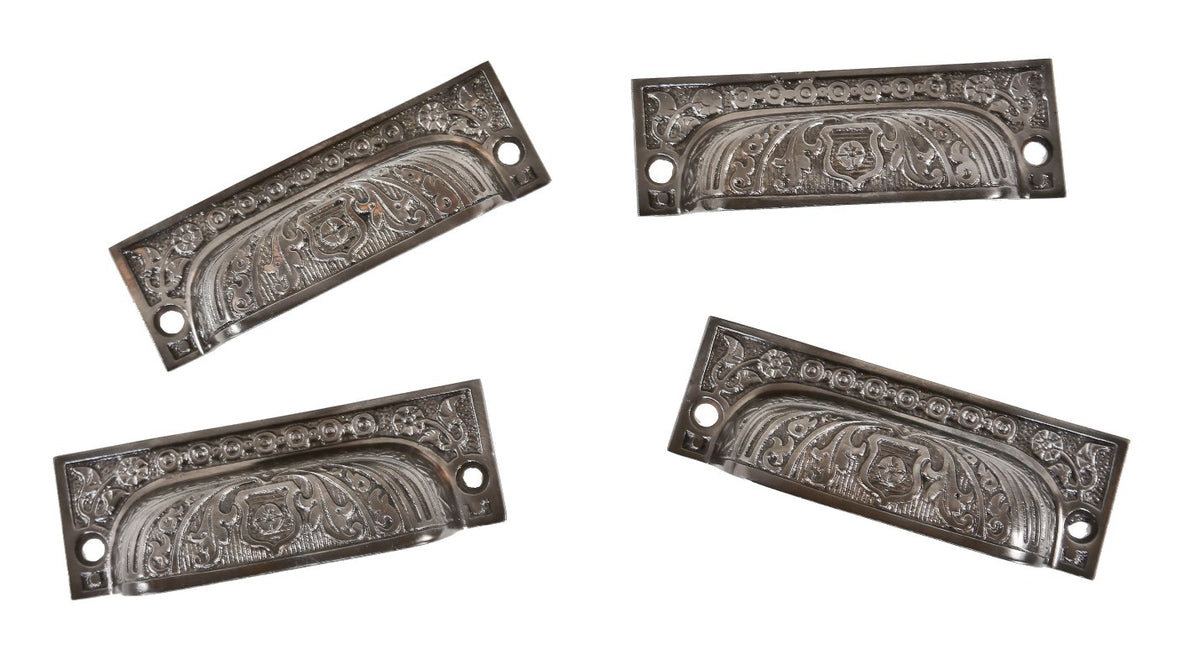 group of four matching original antique american 19th century interior residential ornamental cast iron cabinet door bin or drawer pulls
