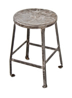 low-lying c. 1930's refinished american industrial all-riveted joint heavy gauge angled steel four-legged stool with inward turned ball feet