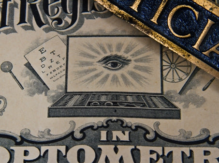 rare early 20th century single-sided diminutive ornamental cast brass optician's office desk plaque with blue enameled inlay